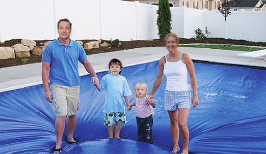 family-walking-on-auto-safety-pool-cover